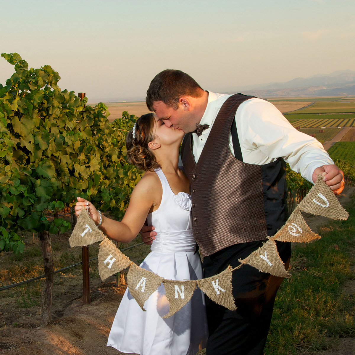 couple kissing in the vineyard on their wedding day