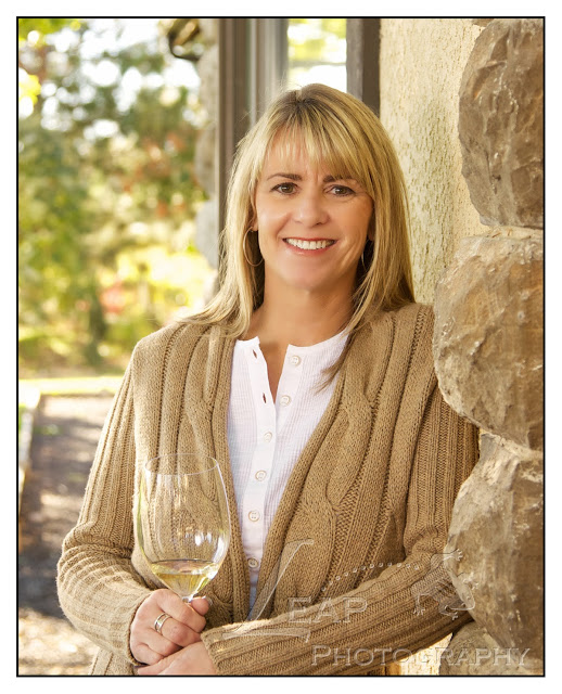Ilene with a glass of wine in hand