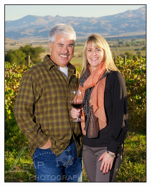 Ilene and her husband standing in an  Idaho vineyard
