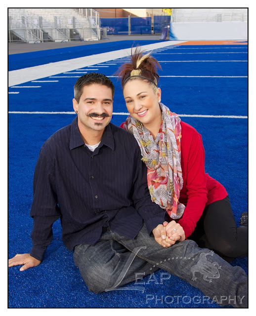 newly engaged couple on the BSU blue turf