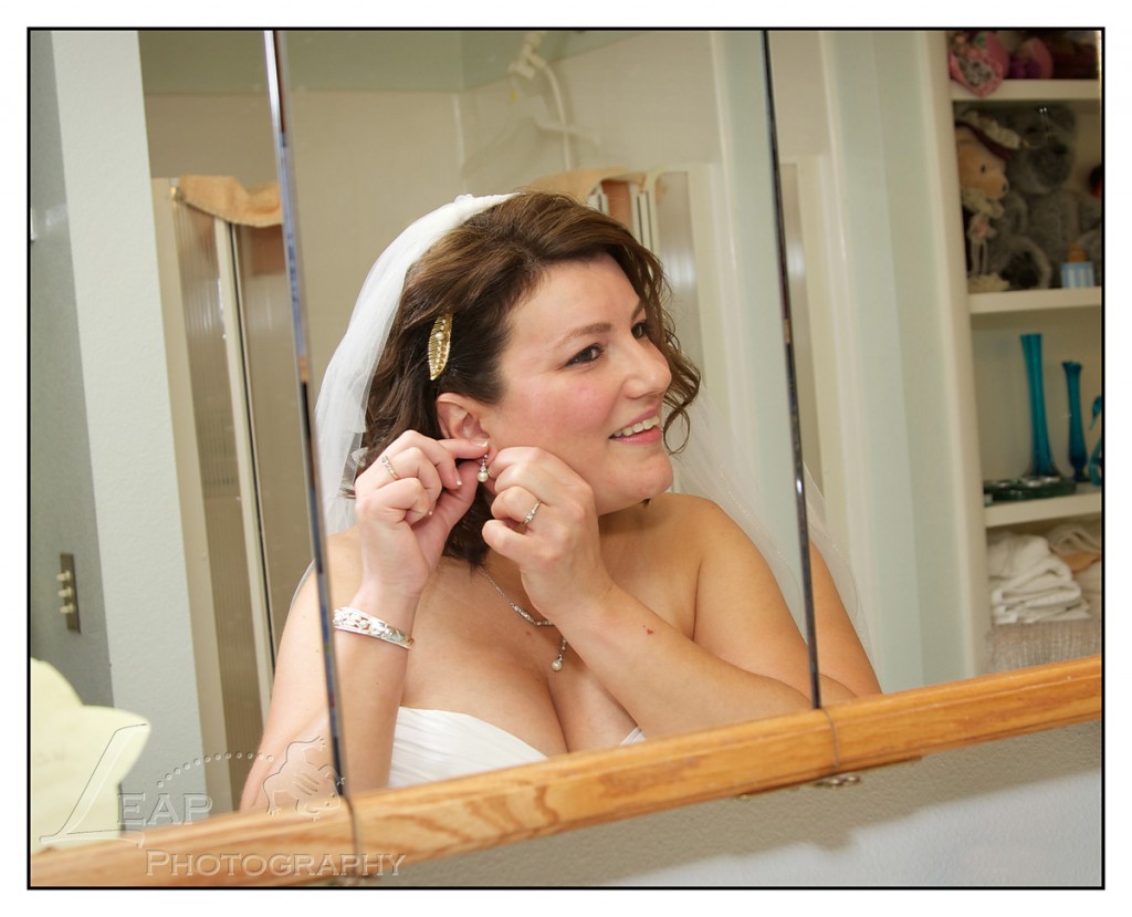 Boise Bride putting on earrings