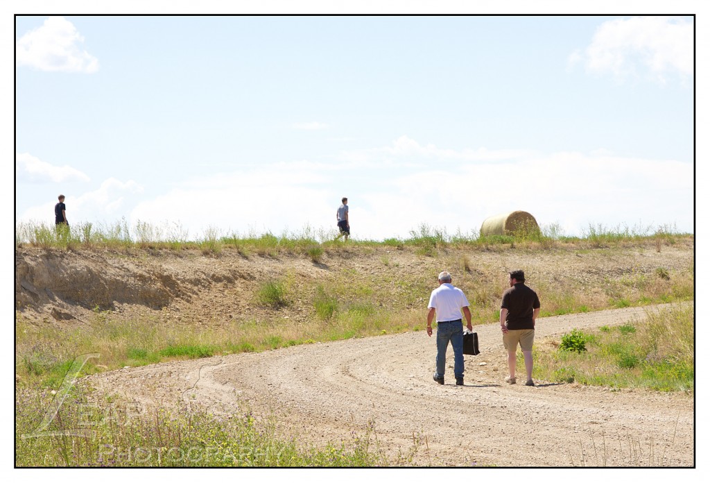 2 men walking on a road