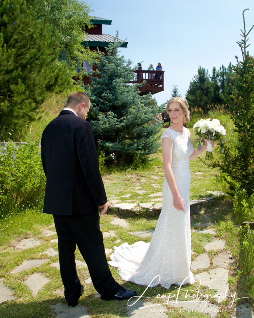 groom admires brides dress