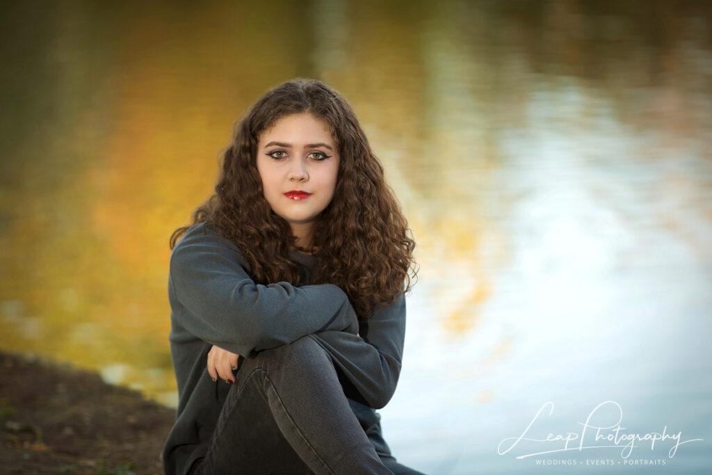 senior photo taken on the boise greenbelt next to water