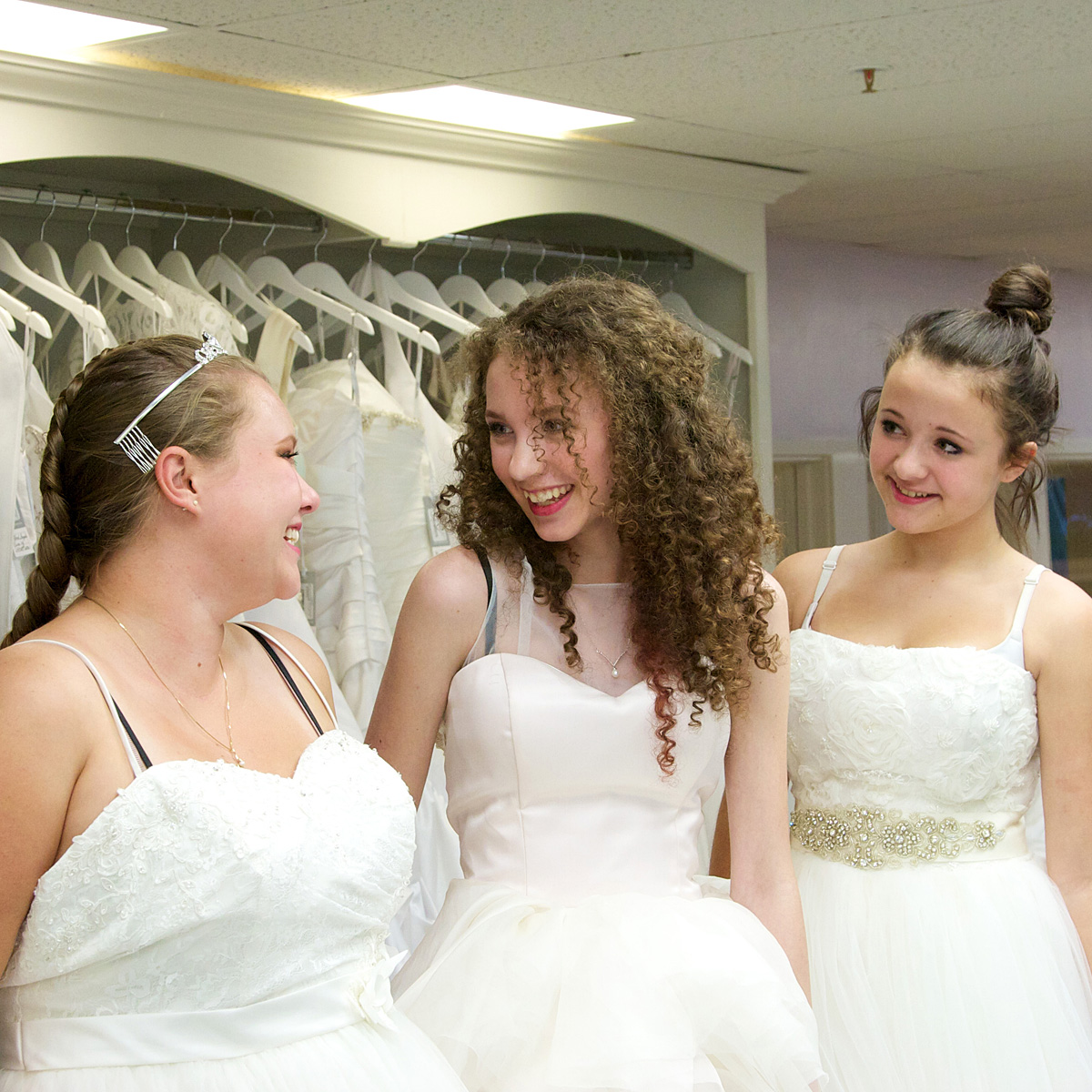 3 sisters trying on wedding dresses